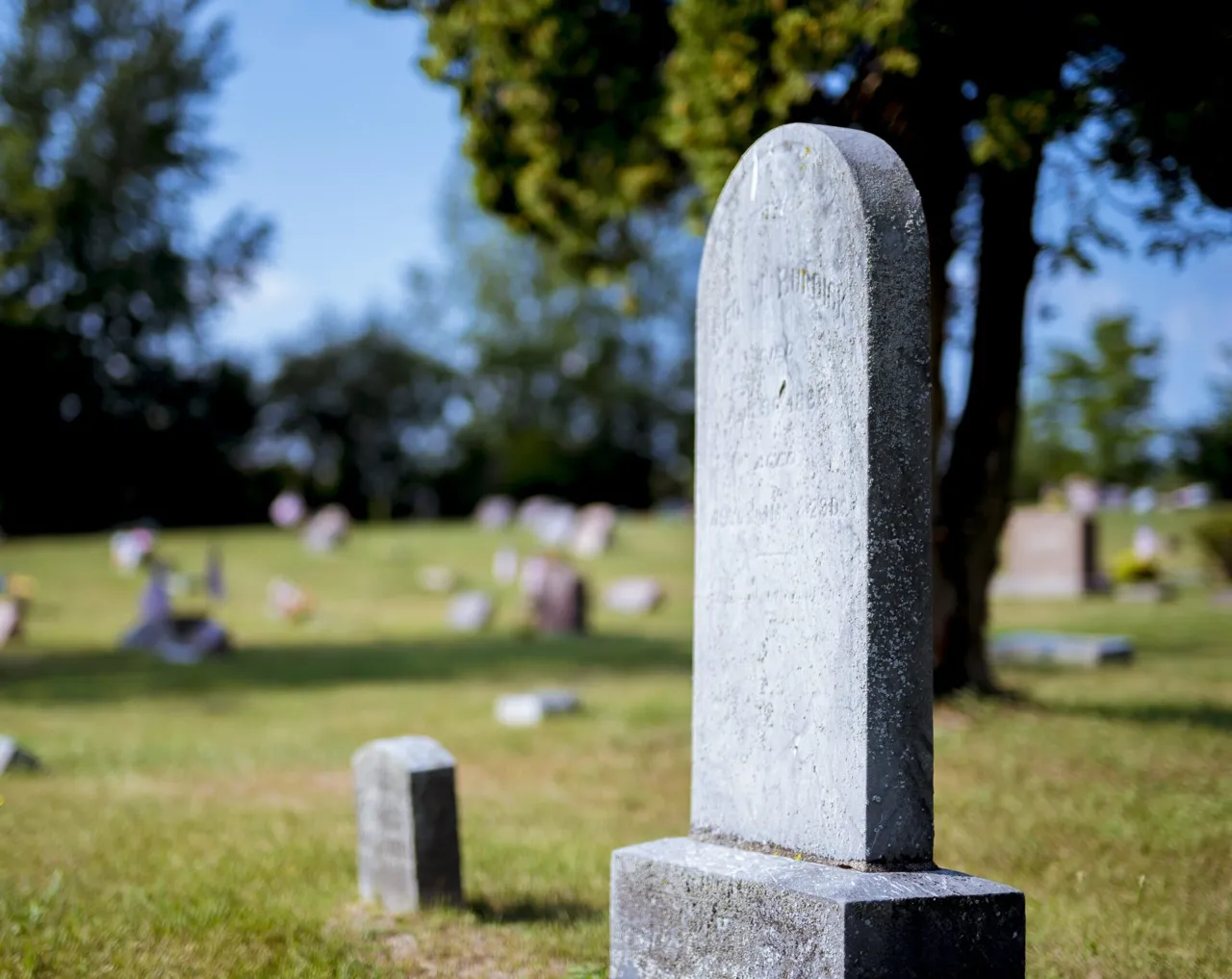 Family visiting the grave of a loved one while working with a Missouri Probate Lawyer.